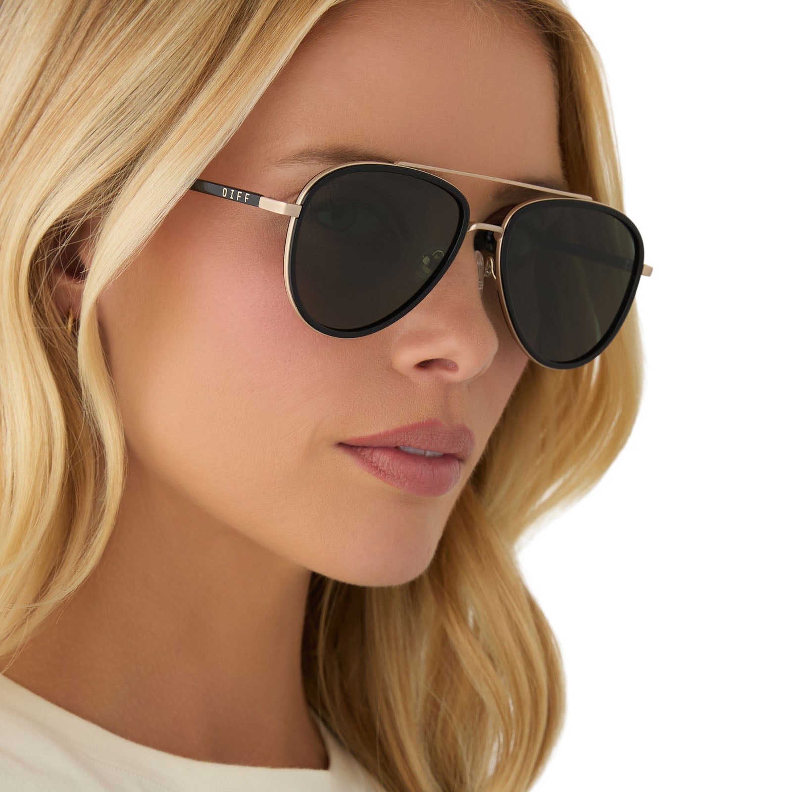 on model - female wearing yellowstone x diff eyewear featuring the yellowstone aviator sunglasses with a black frame and g15 polarized lenses angled view