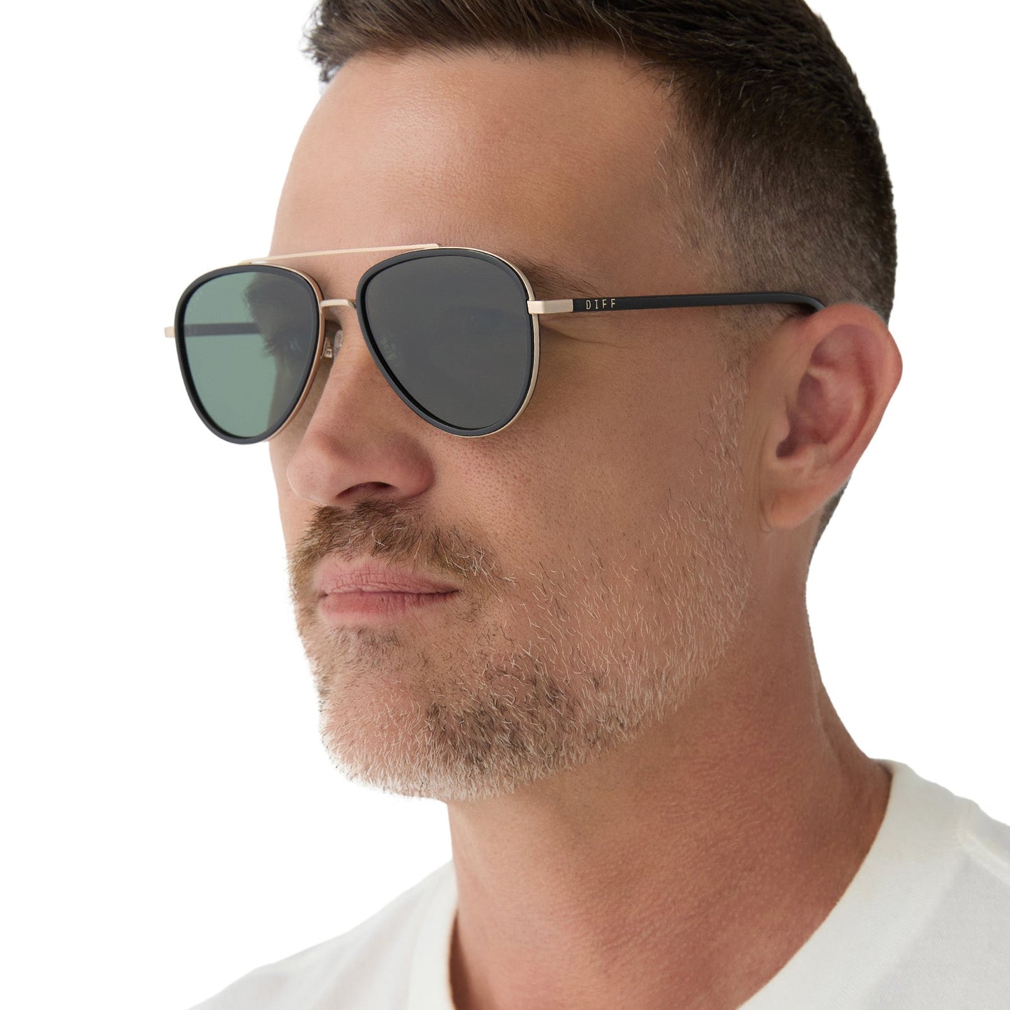 on model - male wearing yellowstone x diff eyewear featuring the yellowstone aviator sunglasses with a black frame and g15 polarized lenses angled view
