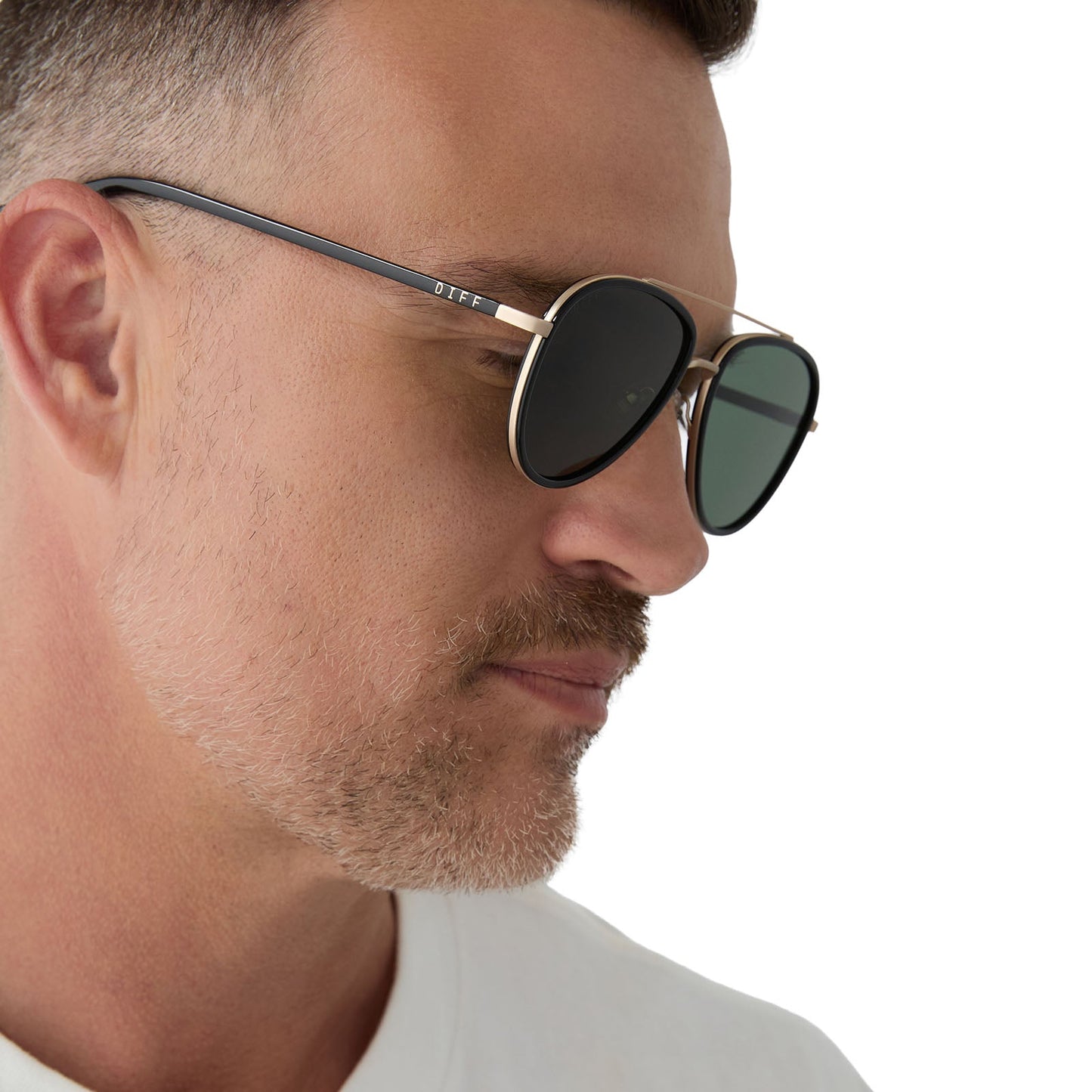 on model - male wearing yellowstone x diff eyewear featuring the yellowstone aviator sunglasses with a black frame and g15 polarized lenses side view