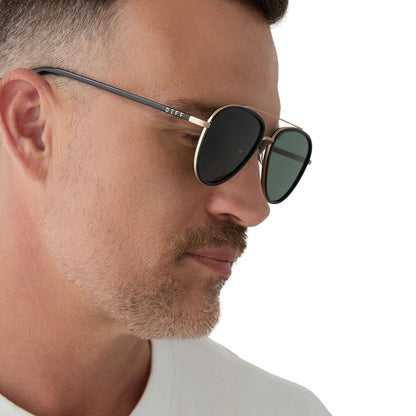 on model - male wearing yellowstone x diff eyewear featuring the yellowstone aviator sunglasses with a black frame and g15 polarized lenses side view