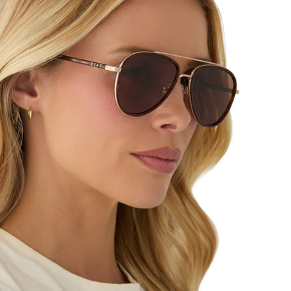on model - female wearing yellowstone x diff eyewear featuring the yellowstone aviator sunglasses with a sequoia tortoise frame and brown polarized lenses angled view