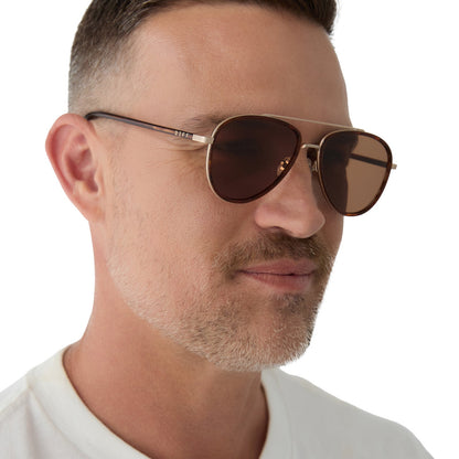 on model - male wearing yellowstone x diff eyewear featuring the yellowstone aviator sunglasses with a sequoia tortoise frame and brown polarized lenses angled view