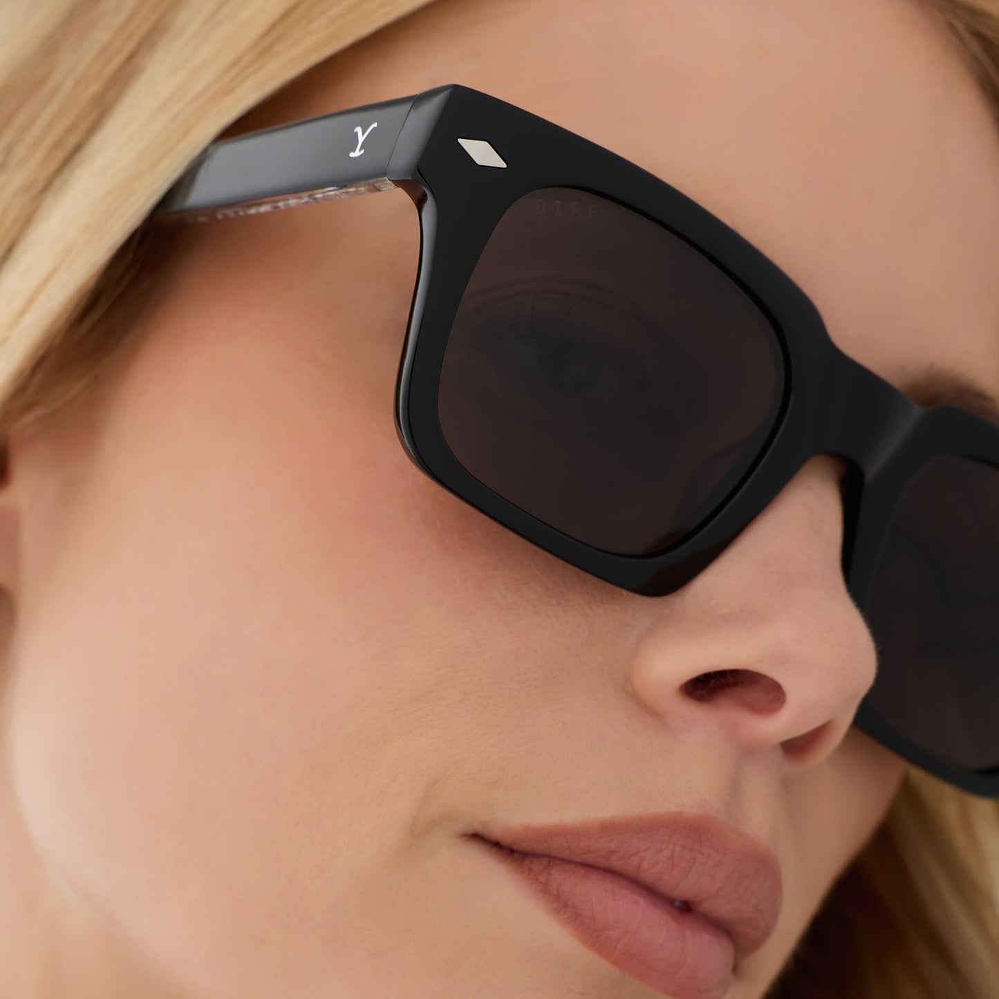 on model - female wearing yellowstone x diff eyewear featuring the kayce dutton square sunglasses with a classic black acetate frame and grey polarized lenses detailed view