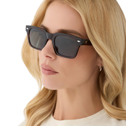 on model - blonde female wearing yellowstone x diff eyewear featuring the kayce dutton square sunglasses with a western sequoia acetate frame and green g15 polarized lenses angled view