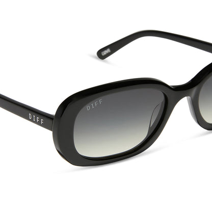 aspyn ovard x diff eyewear featuring the cove oval sunglasses with a black frame and grey gradient lenses detailed view