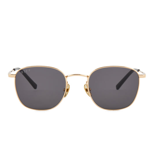 diff eyewear featuring the axel round sunglasses with a gold frame and grey lenses front view