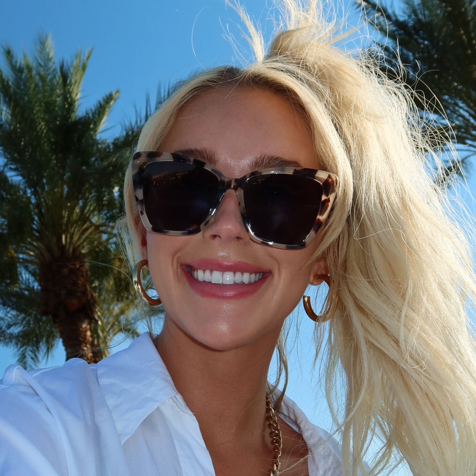 customer content - shelby jones wearing cream tort cat eye frames outside infront of palm trees