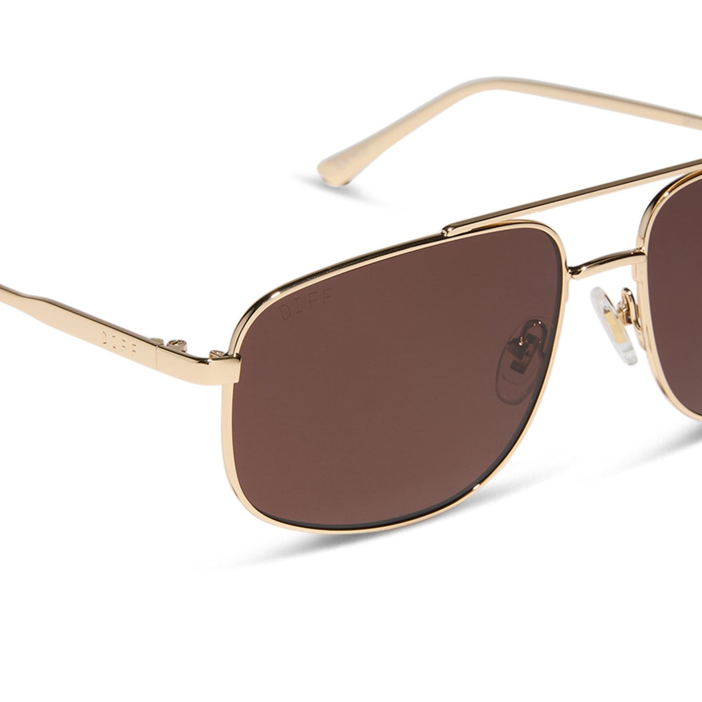diff eyewear featuring the charley navigator sunglasses with a gold metal frame and brown polarized lenses detailed view