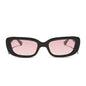 clueless x diff eyewear featuring the cher round sunglasses with a black frame and pink gradient lenses front view