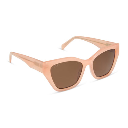 diff eyewear featuring the evie cat eye sunglasses with a peach frame and brown polarized lenses angled view