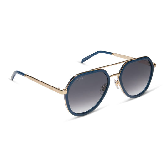 diff eyewear featuring the joey round sunglasses with a clubhouse blue & brushed gold metal frame with grey gradient lenses angled view
