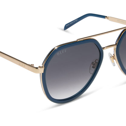 diff eyewear featuring the joey round sunglasses with a clubhouse blue & brushed gold metal frame with grey gradient lenses detailed view