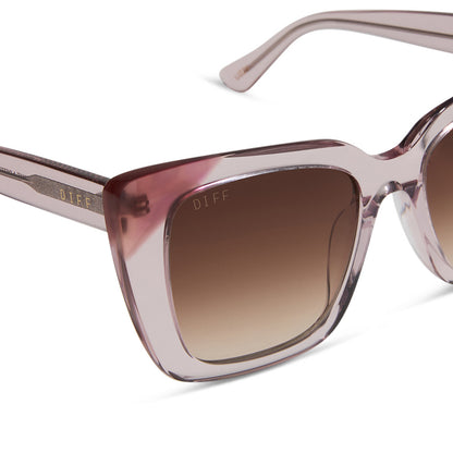 diff eyewear featuring the lizzy cat eye sunglasses with a light pink crystal + fleur pink tort tips frame and brown gradient lenses detailed view