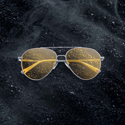 Flatlay of Star Wars x DIFF Luke Skywalker X-Wing sunglasses on rocky black soil with white smoke