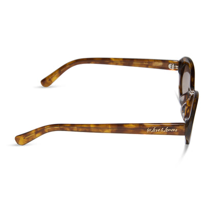 for love and lemons x diff eyewear featuring the sabrina oval sunglasses with a honey tortoise frame and brown gradient lenses side view