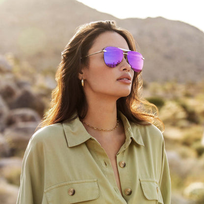 Tahoe gold frame and purple mirror lens on brunette model